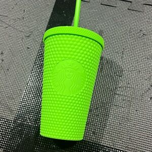 Green studded Starbucks cup